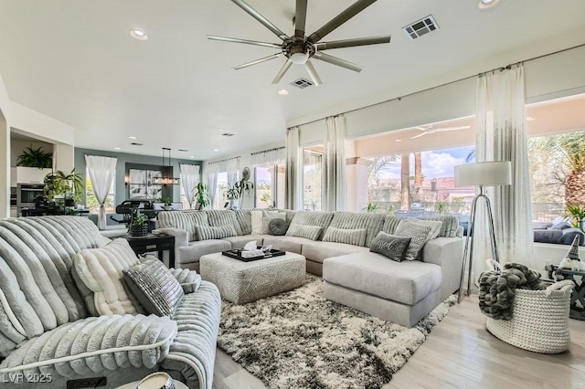 10408 Mezzanino Ct, Las Vegas, NV 89135 - living area featuring a ceiling fan, light wood finished floors, and visible vents