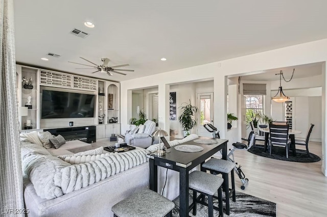 10408 Mezzanino Ct, Las Vegas, NV 89135 - living room featuring light wood finished floors, a ceiling fan, visible vents, and recessed lighting