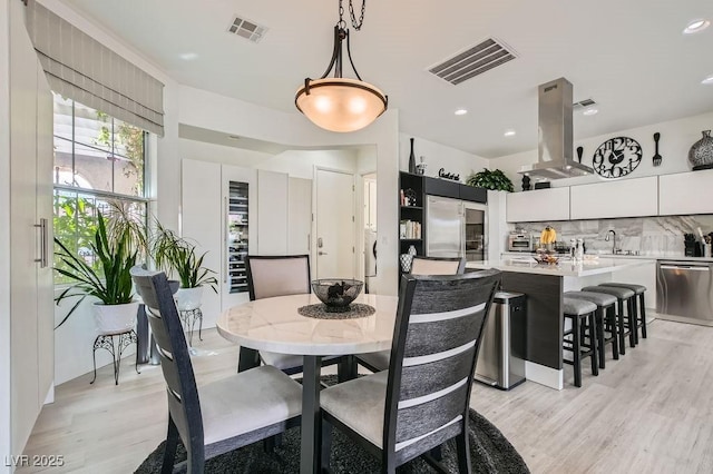 10408 Mezzanino Ct, Las Vegas, NV 89135 - dining room with light wood-style floors, visible vents, a toaster, and recessed lighting