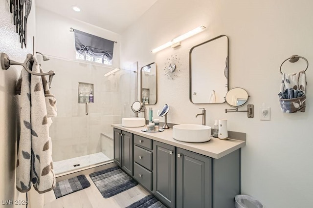 10408 Mezzanino Ct, Las Vegas, NV 89135 - full bath featuring a sink, double vanity, wood finished floors, and a tile shower