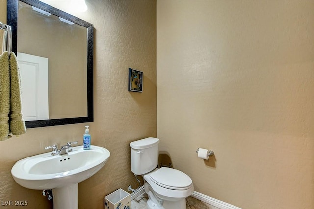 2425 Amatrice St, Henderson, NV 89044 - bathroom featuring a sink, toilet, and baseboards