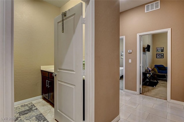 2425 Amatrice St, Henderson, NV 89044 - hall with light tile patterned flooring, baseboards, and visible vents