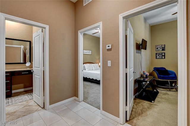 2425 Amatrice St, Henderson, NV 89044 - hall featuring light colored carpet, light tile patterned floors, visible vents, and baseboards