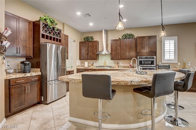 2425 Amatrice St, Henderson, NV 89044 - kitchen featuring a sink, stainless steel appliances, wall chimney range hood, and a breakfast bar