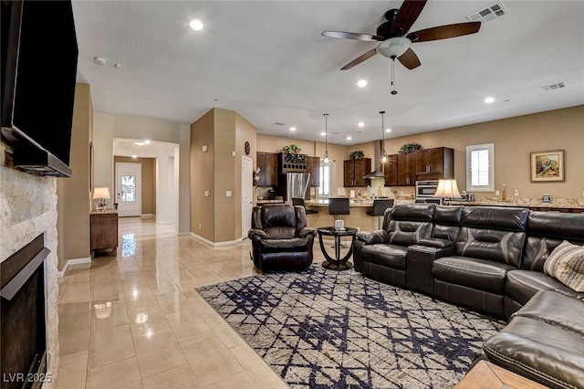 2425 Amatrice St, Henderson, NV 89044 - living area with visible vents, recessed lighting, ceiling fan, baseboards, and a stone fireplace
