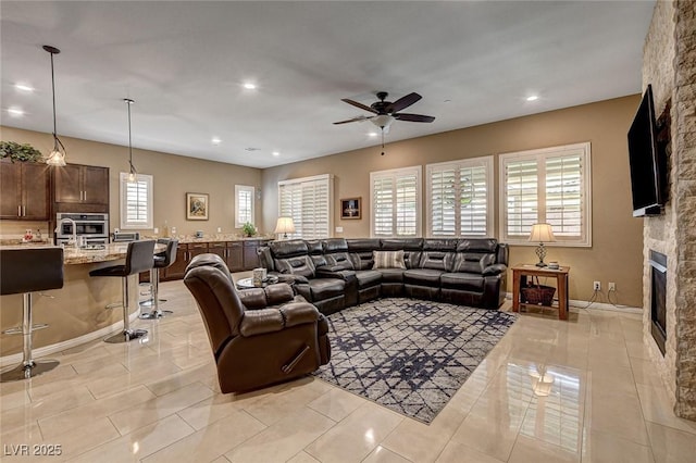 2425 Amatrice St, Henderson, NV 89044 - living area with a fireplace, light tile patterned flooring, ceiling fan, and recessed lighting