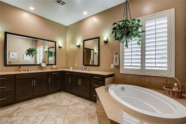 2425 Amatrice St, Henderson, NV 89044 - full bathroom with a sink, double vanity, a garden tub, and visible vents