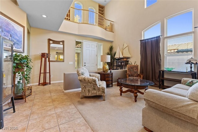 11132 Ferragamo Ct, Las Vegas, NV 89141 - living area featuring light tile patterned floors, baseboards, and a towering ceiling