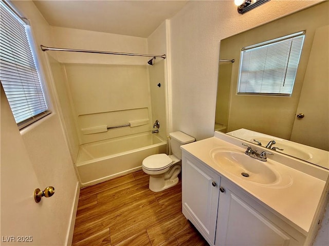 2524 Charleville Ave Unit 102, Las Vegas, NV 89106 - bathroom with toilet, a healthy amount of sunlight, vanity, bathtub / shower combination, and wood finished floors
