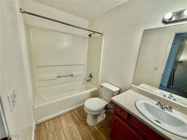 2524 Charleville Ave Unit 102, Las Vegas, NV 89106 - full bathroom featuring toilet, wood finished floors, vanity, and washtub / shower combination