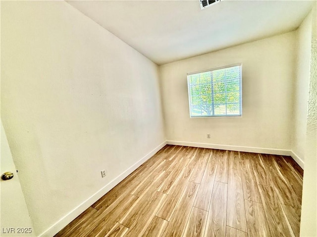 2524 Charleville Ave Unit 102, Las Vegas, NV 89106 - empty room featuring baseboards, visible vents, and wood finished floors