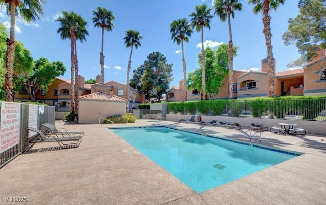 pool featuring a patio area, a residential view, and fence