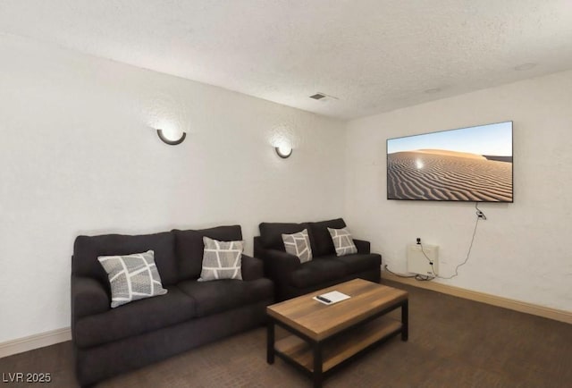 living room featuring a textured ceiling and baseboards