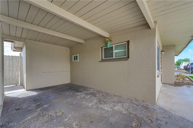 view of patio featuring a carport and fence