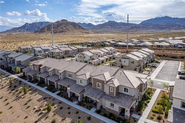 birds eye view of property with a mountain view and a residential view
