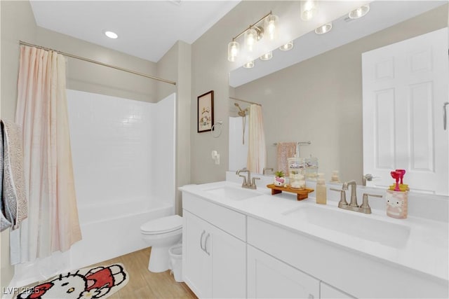 bathroom featuring a sink, double vanity, toilet, and shower / bath combination with curtain