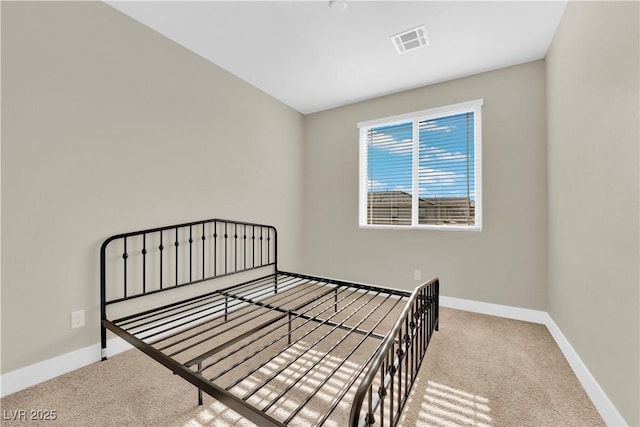 unfurnished bedroom featuring baseboards, carpet flooring, and visible vents