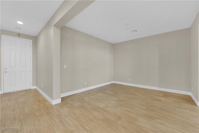 unfurnished room featuring baseboards, recessed lighting, and light wood-type flooring