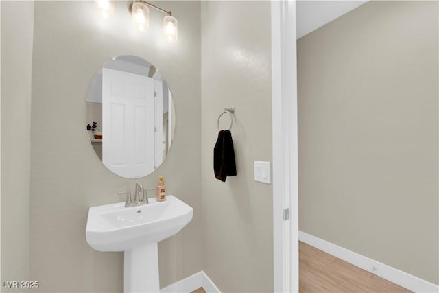 bathroom with baseboards and wood finished floors