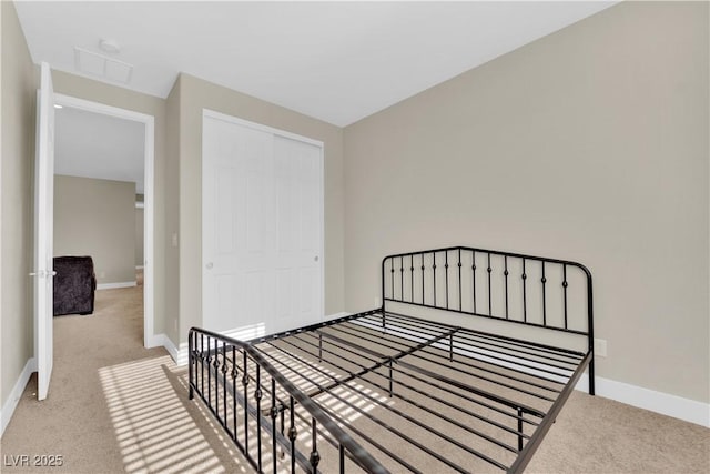 unfurnished bedroom featuring carpet flooring, baseboards, and visible vents