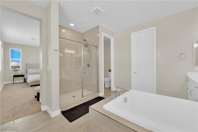 full bath featuring toilet, visible vents, a stall shower, baseboards, and a bath