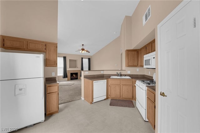 kitchen featuring a sink, white appliances, high vaulted ceiling, visible vents, and ceiling fan
