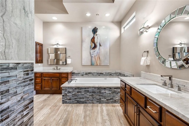 9500 Balatta Canyon Ct, Las Vegas, NV 89144 - full bathroom with a bath, two vanities, wood finished floors, and recessed lighting