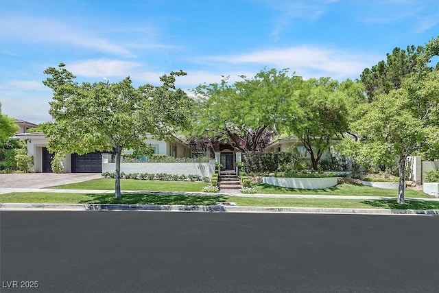 9500 Balatta Canyon Ct, Las Vegas, NV 89144 - view of property hidden behind natural elements featuring a garage, driveway, and a front yard