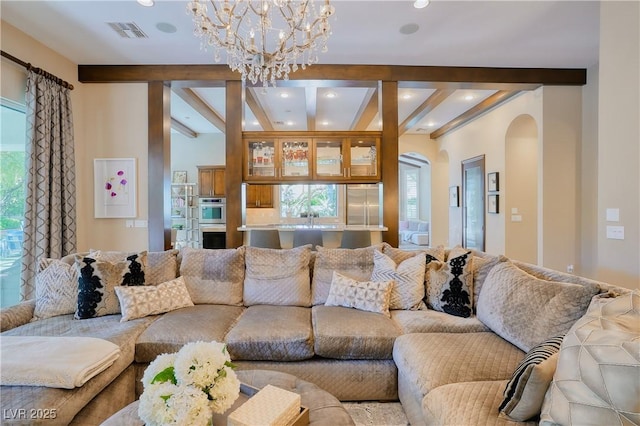 9500 Balatta Canyon Ct, Las Vegas, NV 89144 - living area featuring beamed ceiling, arched walkways, healthy amount of natural light, a chandelier, and recessed lighting