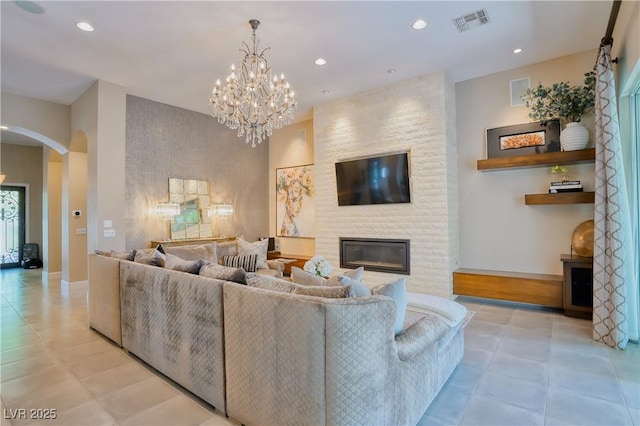 9500 Balatta Canyon Ct, Las Vegas, NV 89144 - living area featuring arched walkways, a chandelier, baseboards, a brick fireplace, and recessed lighting