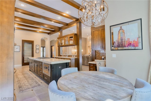 9500 Balatta Canyon Ct, Las Vegas, NV 89144 - dining room featuring arched walkways, a chandelier, beamed ceiling, recessed lighting, and light tile patterned flooring