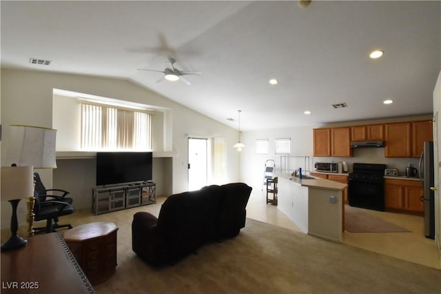living area with vaulted ceiling, a wealth of natural light, a ceiling fan, and visible vents