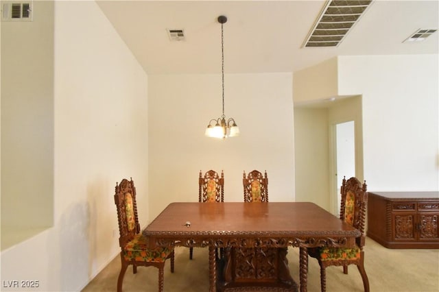 carpeted dining area featuring visible vents and a notable chandelier