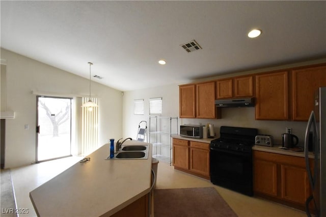 kitchen featuring a sink, stainless steel appliances, brown cabinets, visible vents, and under cabinet range hood