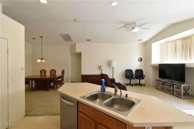 kitchen with ceiling fan with notable chandelier, a sink, stainless steel dishwasher, light colored carpet, and lofted ceiling