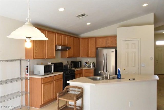 kitchen featuring black appliances, visible vents, under cabinet range hood, vaulted ceiling, and light countertops