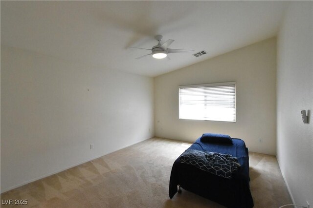 sitting room featuring vaulted ceiling, carpet, visible vents, and ceiling fan