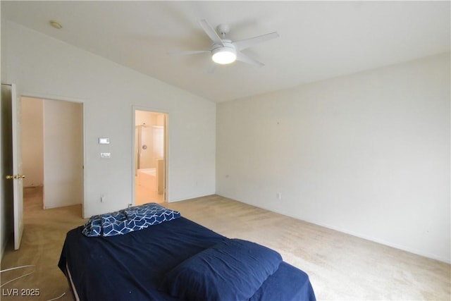 bedroom with lofted ceiling, light carpet, ensuite bath, and a ceiling fan