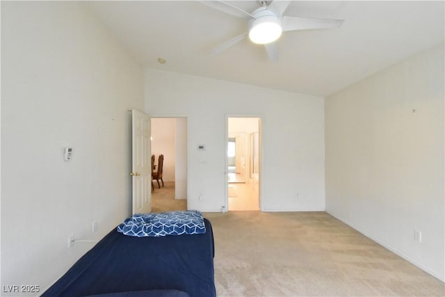 bedroom with light colored carpet, vaulted ceiling, and a ceiling fan