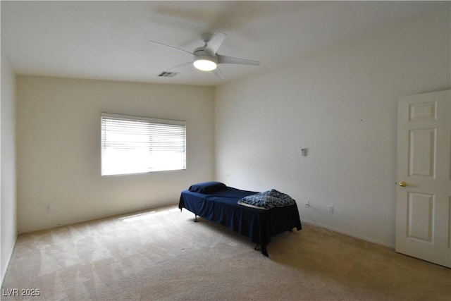 carpeted bedroom featuring a ceiling fan and visible vents