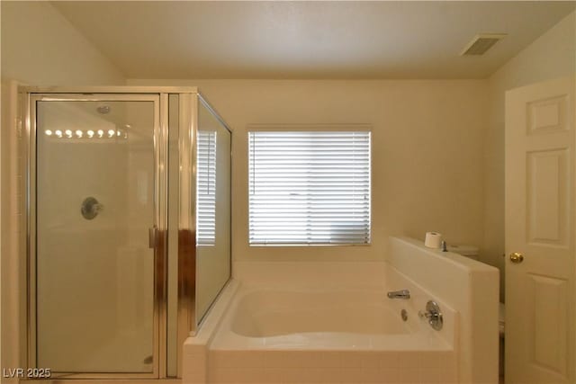 full bathroom with a stall shower, a bath, and visible vents