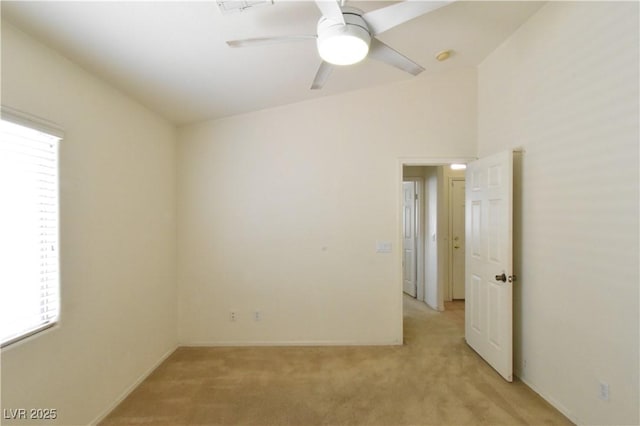 spare room featuring baseboards, plenty of natural light, ceiling fan, and light colored carpet