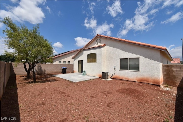 back of house featuring a patio area, stucco siding, a tile roof, and a fenced backyard