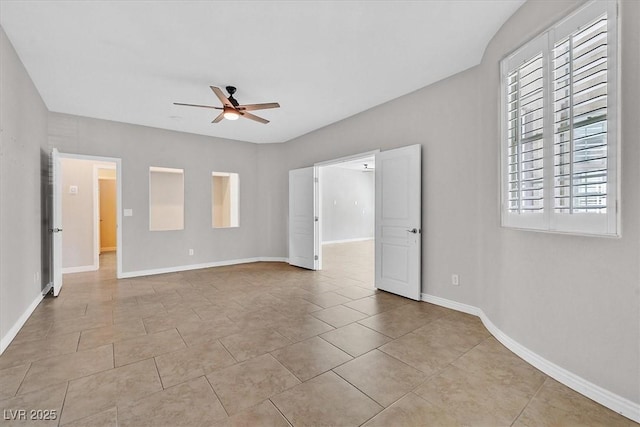 interior space featuring baseboards, tile patterned flooring, and ceiling fan