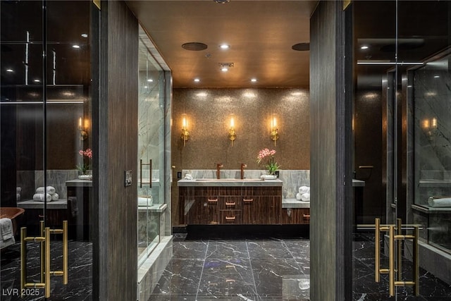 bathroom featuring a shower stall, marble finish floor, vanity, and recessed lighting