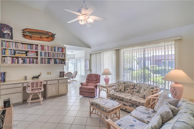 living area with a ceiling fan, light tile patterned floors, and vaulted ceiling