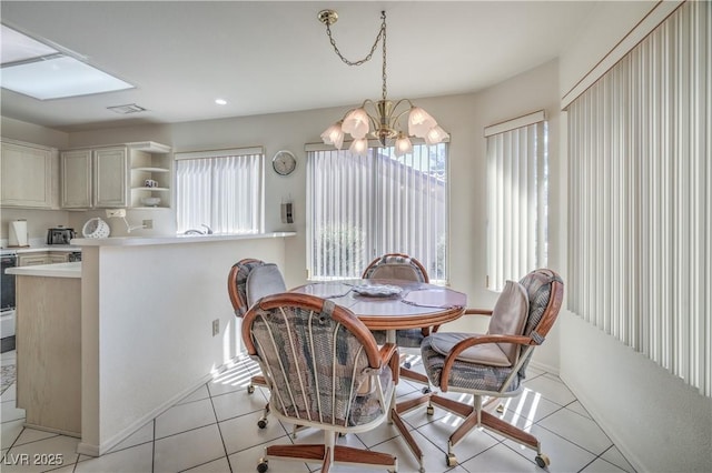 dining space featuring an inviting chandelier, baseboards, light tile patterned flooring, and recessed lighting