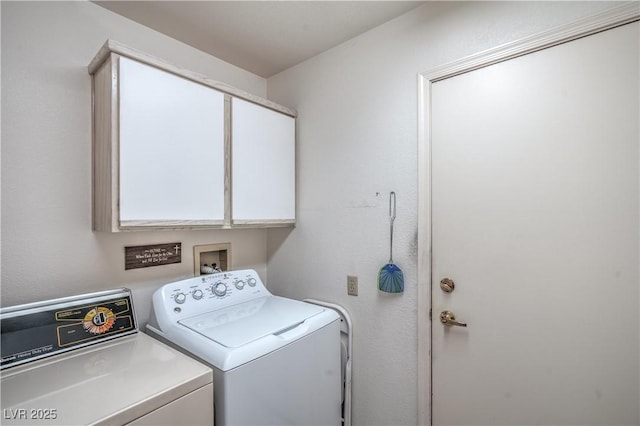 laundry room featuring separate washer and dryer and cabinet space