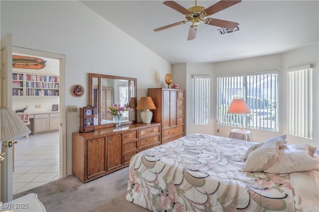 bedroom featuring light colored carpet, visible vents, and lofted ceiling