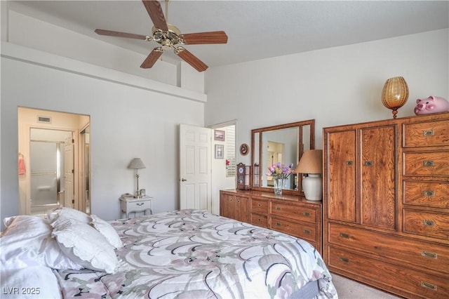 carpeted bedroom with ensuite bath, a ceiling fan, and visible vents